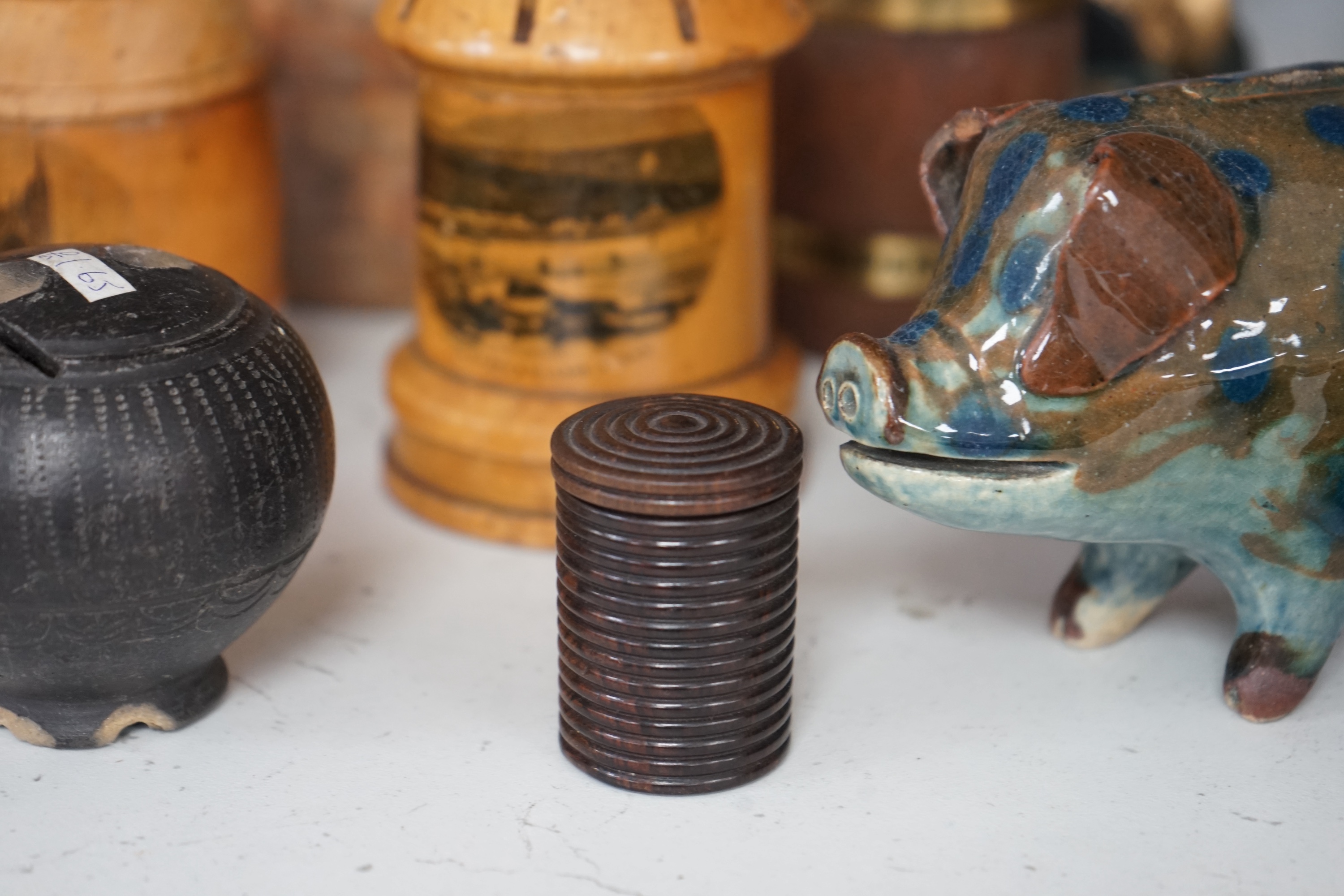 A collection of mixed tin wood and ceramic money boxes to include Cadbury’s milk chocolate, three in the form of trunks and a ceramic pig. Condition - varies